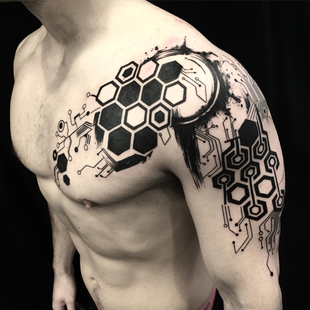 Hexagon and circuit design tattoo, covering the shoulder with bold black patterns